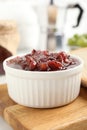 Delicious gooseberry jam in bowl on wooden board, closeup Royalty Free Stock Photo