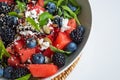 Delicious gourmet summer salad with feta, watermelon, berries and balsamic vinegar dressing