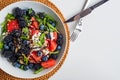 Delicious gourmet summer salad with feta, watermelon, berries and balsamic vinegar dressing