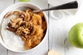 Low carb protein breakfast bowl with islandic skyr, grated apples and nuts on white table background. top view