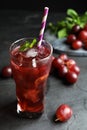 Delicious grape soda water on black table. Refreshing drink