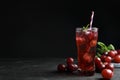 Delicious grape soda water on black table, space for text. Refreshing drink