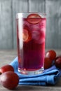 Delicious grape soda water on grey table. Refreshing drink