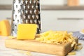 Delicious grated cheese on white marble table in kitchen