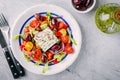 Delicious Greek salad with feta cheese, olives, tomatoes, cucumbers, paprika and red onions. Royalty Free Stock Photo