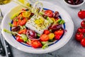 Delicious Greek salad with feta cheese, olives, tomatoes, cucumbers, paprika and red onions. Royalty Free Stock Photo