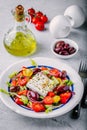 Delicious Greek salad with feta cheese, olives, tomatoes, cucumbers, paprika and red onions. Royalty Free Stock Photo