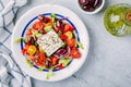 Delicious Greek salad with feta cheese, olives, tomatoes, cucumbers, paprika and red onions. Royalty Free Stock Photo