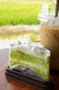 Delicious green chiffon cake or coconut pandan cake with iced coffee on the table. Royalty Free Stock Photo