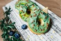 Delicious green doughnuts with berries Royalty Free Stock Photo