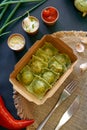 Delicious Green Ravioli Platter with Fresh Ingredients and Sauces for an Inviting Culinary Experience on a Rustic Royalty Free Stock Photo