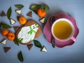 Delicious green tea in a pink ceramic pair with a painted gingerbread in the shape of a polar bear