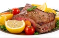 Delicious grilled beef with vegetables and lemon, cut out isolated on white background