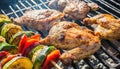 delicious grilled chicken meat shish kebob or kabob with vegetables on barbecue grill with smoke and flames. popular outdoor Royalty Free Stock Photo