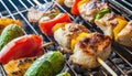 delicious grilled chicken meat shish kebob or kabob with vegetables on barbecue grill with smoke and flames. popular outdoor Royalty Free Stock Photo