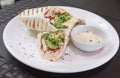 Delicious Grilled Chicken Shawarma with fresh lettuce with a serving of toum or garlic mayonnaise