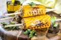 Delicious grilled corn on wooden background closeup. Royalty Free Stock Photo