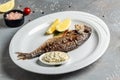 Delicious Grilled dorado fish with lemon and parsley. Whole Bbq sea bream baked. Dorado grill. Top view Royalty Free Stock Photo