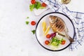 Delicious grilled dorado or sea bream fish with salad, spices, grilled dorada on a plate. Royalty Free Stock Photo