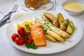 Delicious grilled filet of salmon with white asparagus