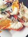 Delicious Grilled Giant River Prawn with pieces of chilli and parsley on white dish with soy sauce in small bowl in centre, on woo Royalty Free Stock Photo