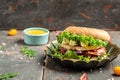 Delicious grilled hamburger with feta cheese and chicken beef on a wooden table. symbol of diet temptation resulting in unhealthy Royalty Free Stock Photo