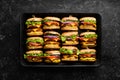 Delicious grilled homemade burgers with beef, tomatoes, cheese, onions and salad. Burger menu. Royalty Free Stock Photo