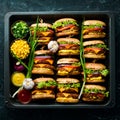 Delicious grilled homemade burgers with beef, tomatoes, cheese, onions and salad. Burger menu. Royalty Free Stock Photo