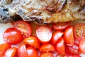 Delicious grilled juicy pork meat steak with vegetables cherry tomatoes close up Royalty Free Stock Photo