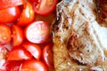 Delicious grilled juicy pork meat steak with vegetables cherry tomatoes close up Royalty Free Stock Photo