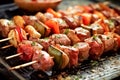 Delicious grilled meat skewers with vegetables, shashlik. BBQ time. Barbecue party.