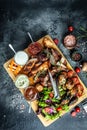 delicious grilled meat with vegetable. Mixed grilled bbq meat with vegetables on wooden platter. Restaurant menu Royalty Free Stock Photo