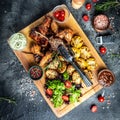 Delicious grilled meat with vegetable. Mixed grilled bbq meat with vegetables on wooden platter. Restaurant menu, dieting, Royalty Free Stock Photo