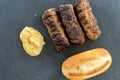 Delicious grilled minced meat rolls mici ori mititei traditional romanian and balkan dish served with mustard and bread tradition Royalty Free Stock Photo