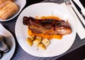 Grilled pork ribs with BBQ sauce, sweet potato puree and baked potatoes Royalty Free Stock Photo