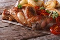 Delicious grilled rabbit leg with apples and tomatoes