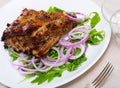 Grilled rack of pork with arugula and onion Royalty Free Stock Photo