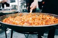 Delicious grilled ravioli in tomato sauce cooked in a large frying pan street food Royalty Free Stock Photo