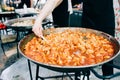 Delicious grilled ravioli in tomato sauce cooked in a large frying pan street food Royalty Free Stock Photo