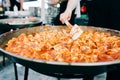 Delicious grilled ravioli in tomato sauce cooked in a large frying pan street food Royalty Free Stock Photo