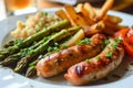 Delicious grilled sausage meal with vegetables and fries on a plate Royalty Free Stock Photo