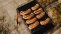 Delicious grilled sausages resting on the iron grid of a portable barbecue Royalty Free Stock Photo
