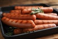 Delicious grilled sausages with rosemary on table Royalty Free Stock Photo