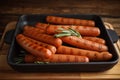 Delicious grilled sausages with rosemary on wooden table Royalty Free Stock Photo