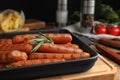 Delicious grilled sausages with rosemary on table, closeup Royalty Free Stock Photo