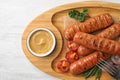 Delicious grilled sausages with sauce on tray, top view. Barbecue food