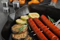 Delicious grilled sausages and vegetables on  table, closeup Royalty Free Stock Photo