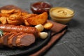 Delicious grilled sausages and  on grey table, closeup. Space for text Royalty Free Stock Photo