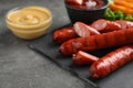 Delicious grilled sausages and on grey table, closeup. Space for text Royalty Free Stock Photo