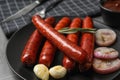 Delicious grilled sausages and on plate, closeup. Barbecue food